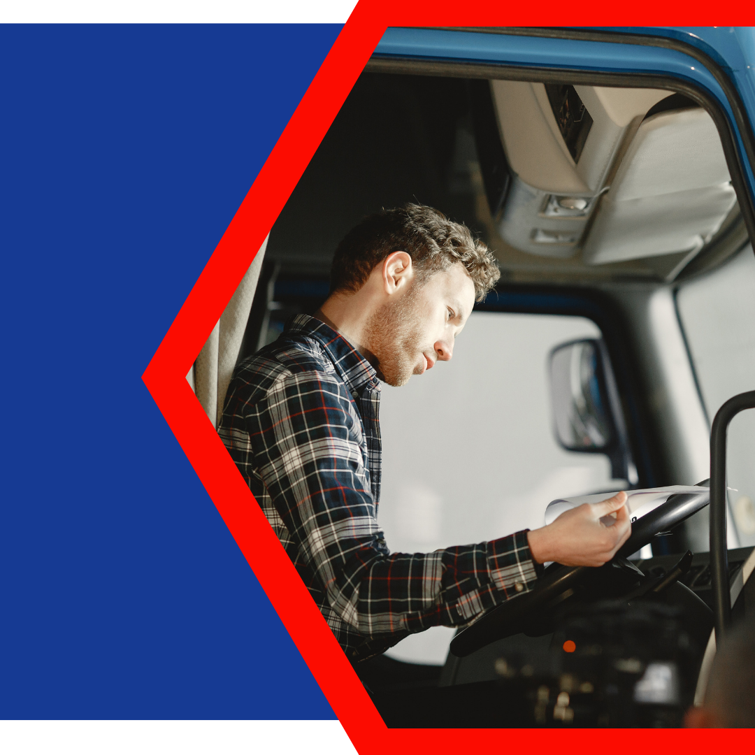 truck driver looking over paperwork in cab